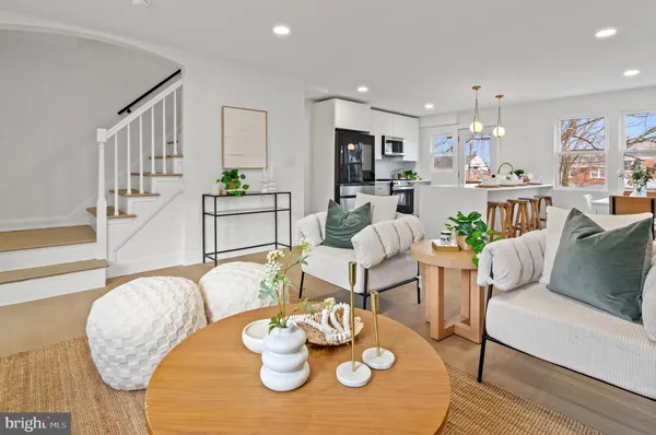 a living room with furniture kitchen view and a table