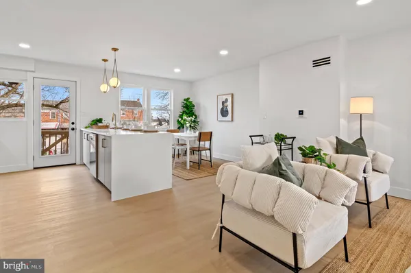 a living room with furniture and a chandelier