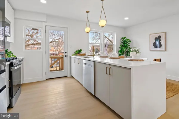 a kitchen with stainless steel appliances a white stove top oven and a refrigerator