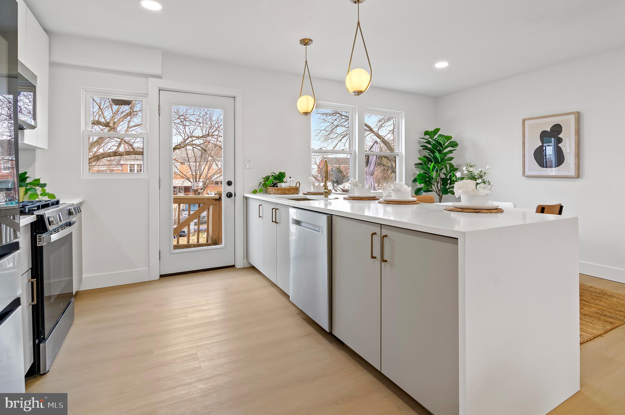 5905 Glenkirk Road Baltimore, MD 21239 - Photo 10 of 31 a kitchen with stainless steel appliances a white stove top oven and a refrigerator