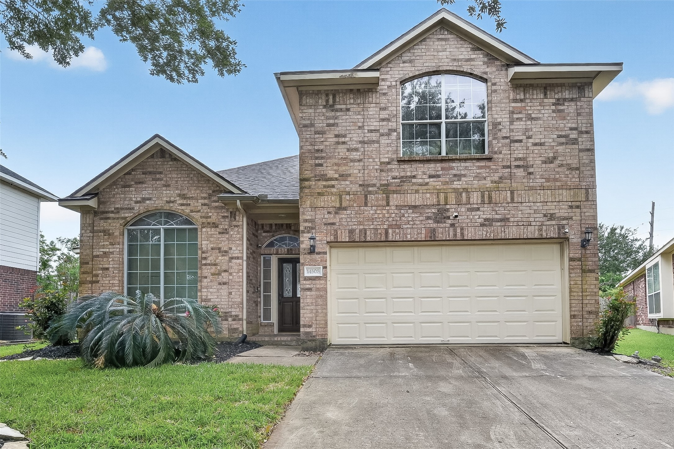 14308 Rocky Briar Lane Rosharon, TX 77583 - Photo 1 of 46 a front view of a house with a yard and garage