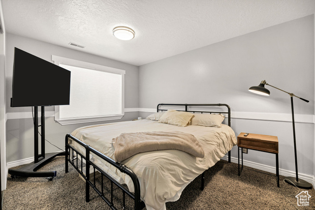 2280 South 450 West Perry, UT 84302 - Photo 29 of 38 Carpeted bedroom with a textured ceiling and baseboards