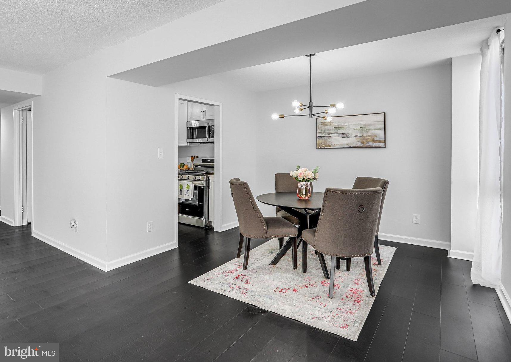 1836 Metzerott Road, Unit 627 Adelphi, MD 20783 - Photo 11 of 27 a view of a dining room with furniture and wooden floor
