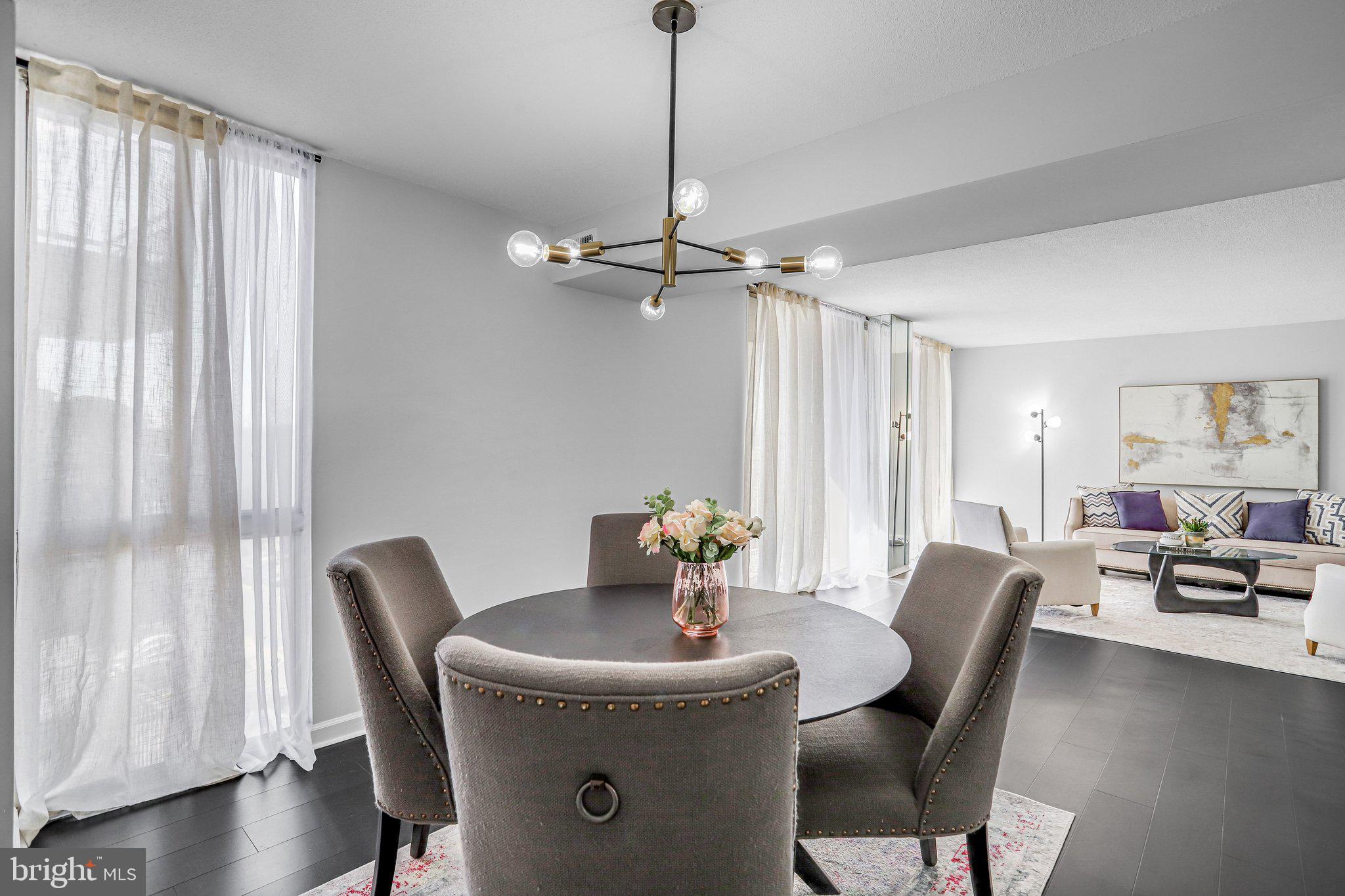 1836 Metzerott Road, Unit 627 Adelphi, MD 20783 - Photo 13 of 27 a view of a dining room with furniture window and wooden floor