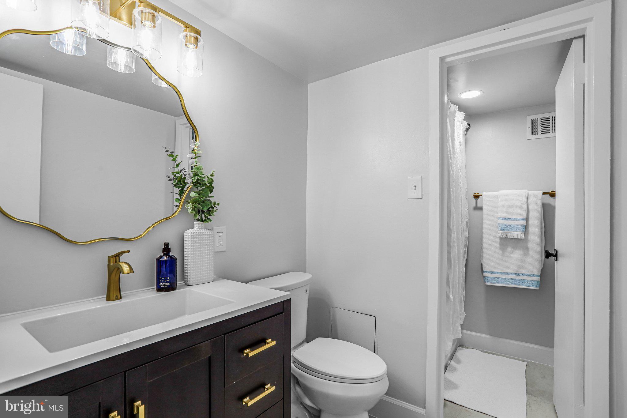 1836 Metzerott Road, Unit 627 Adelphi, MD 20783 - Photo 14 of 27 a bathroom with a toilet sink and mirror