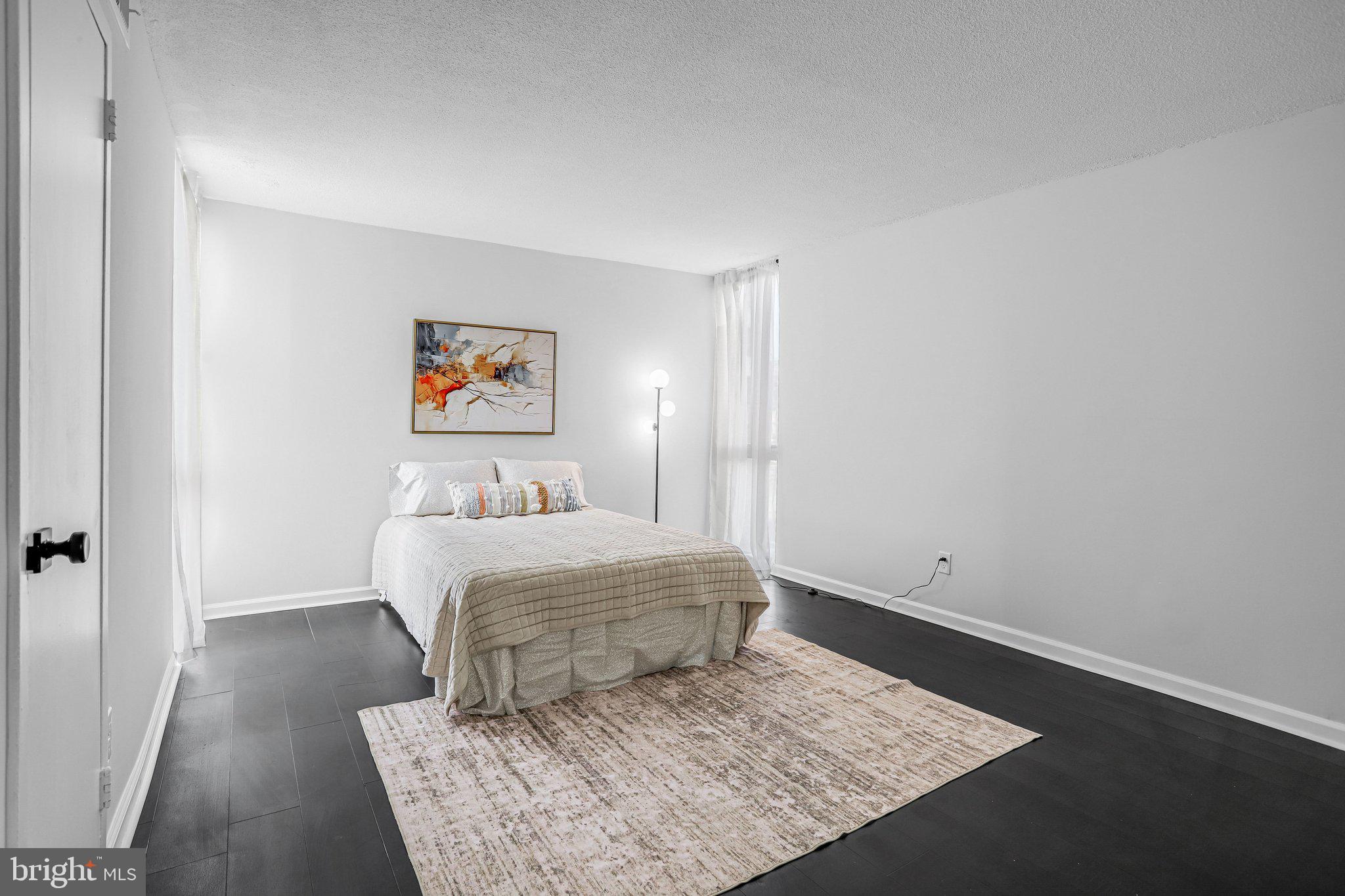 1836 Metzerott Road, Unit 627 Adelphi, MD 20783 - Photo 15 of 27 a room with a bed and a rug