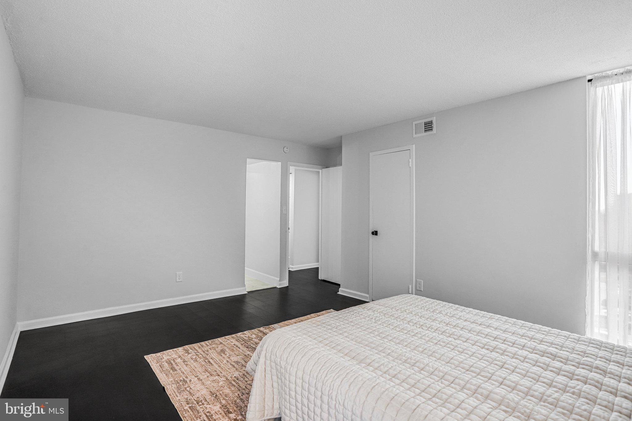 1836 Metzerott Road, Unit 627 Adelphi, MD 20783 - Photo 17 of 27 a bedroom with a bed and a night stand