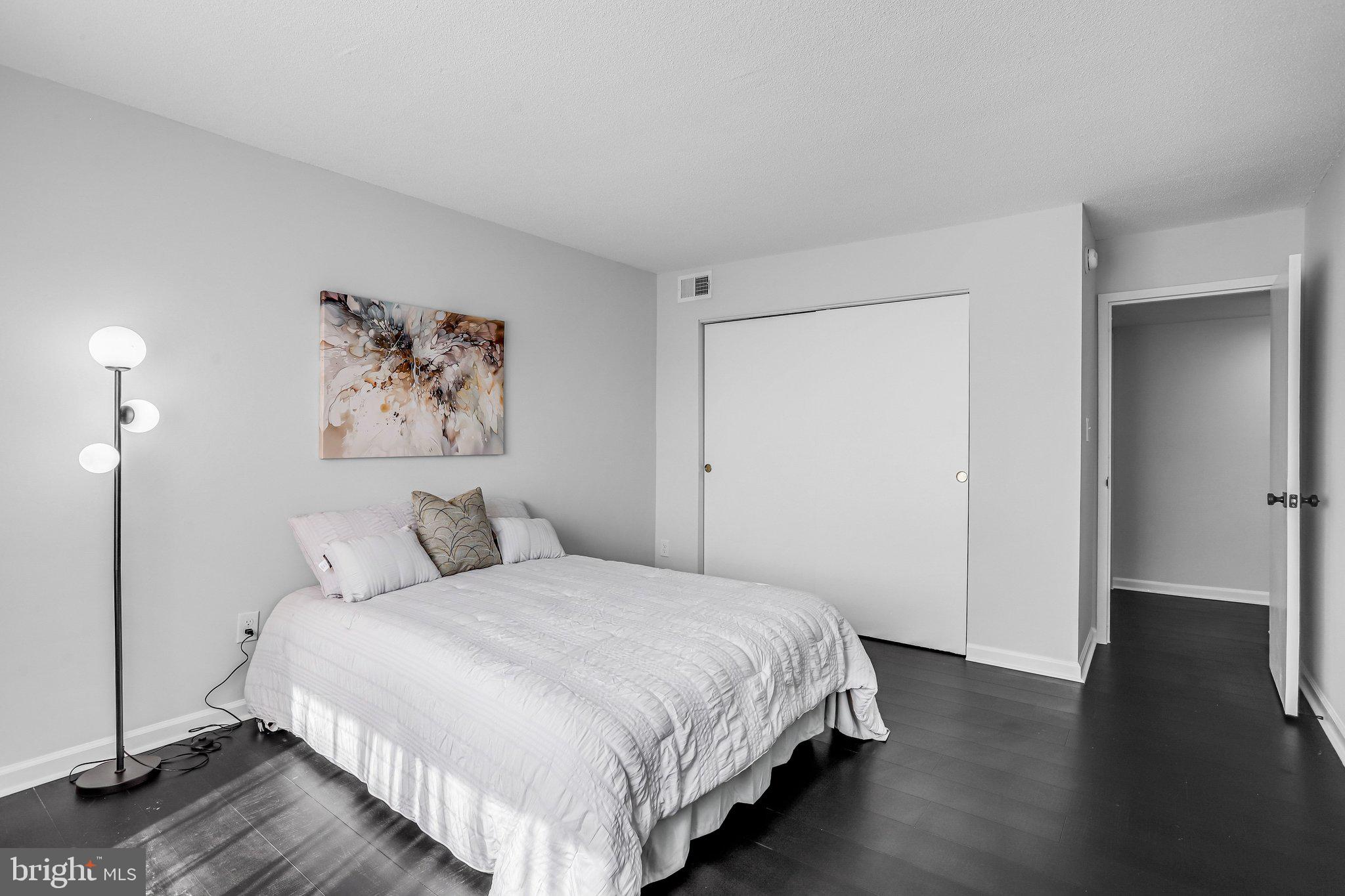 1836 Metzerott Road, Unit 627 Adelphi, MD 20783 - Photo 21 of 27 a bedroom with a bed and a painting on the wall