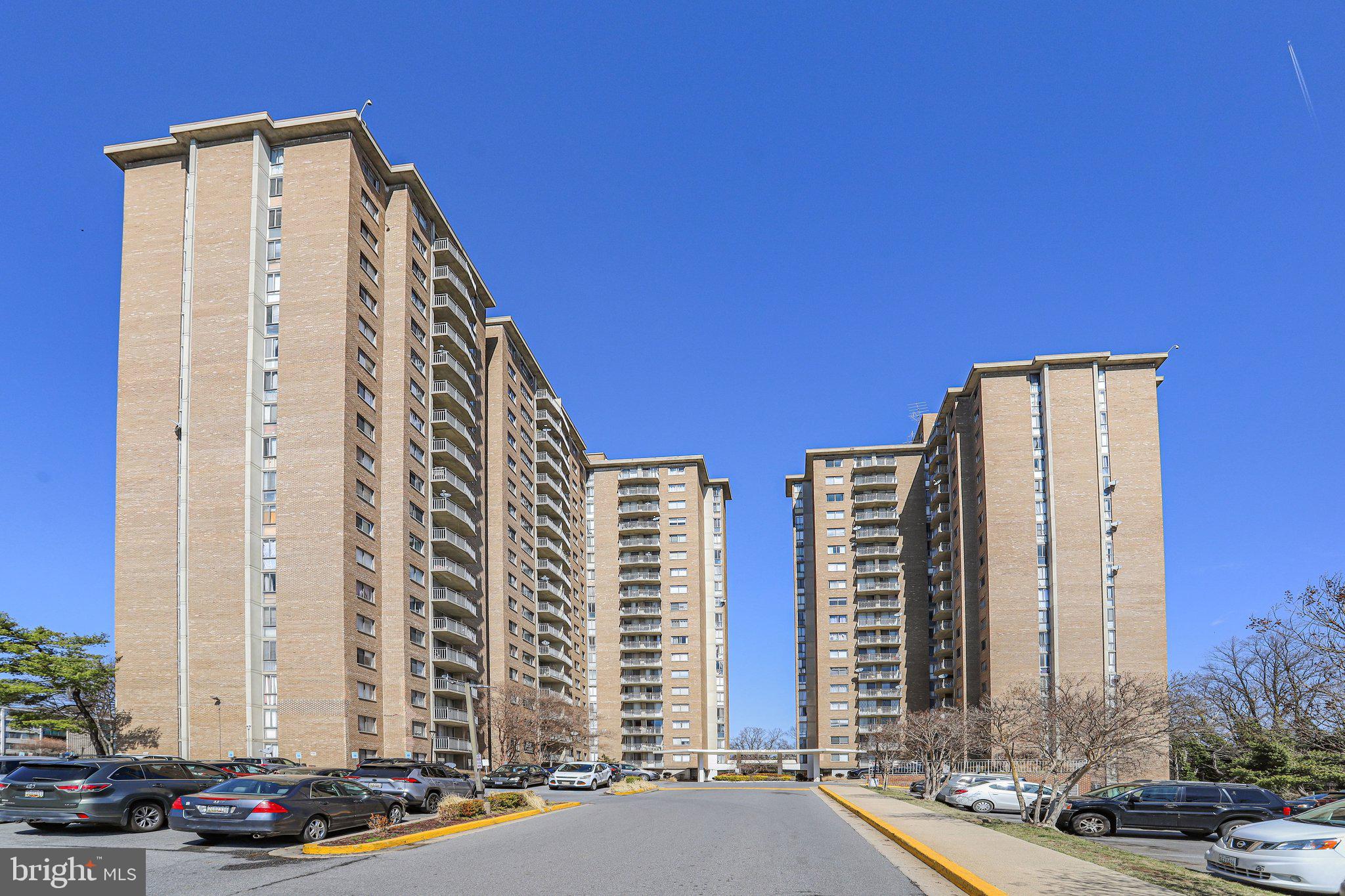 1836 Metzerott Road, Unit 627 Adelphi, MD 20783 - Photo 27 of 27 a front view of a building with lot of cars and trees