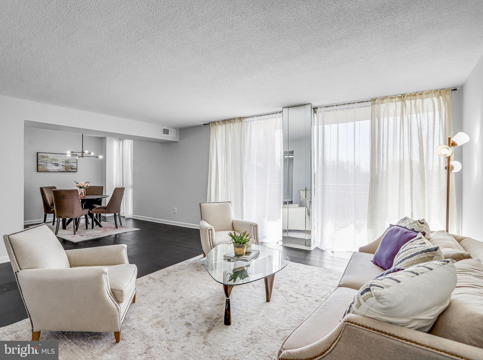1836 Metzerott Road, Unit 627 Adelphi, MD 20783 - Photo 6 of 27 a living room with furniture and a large window