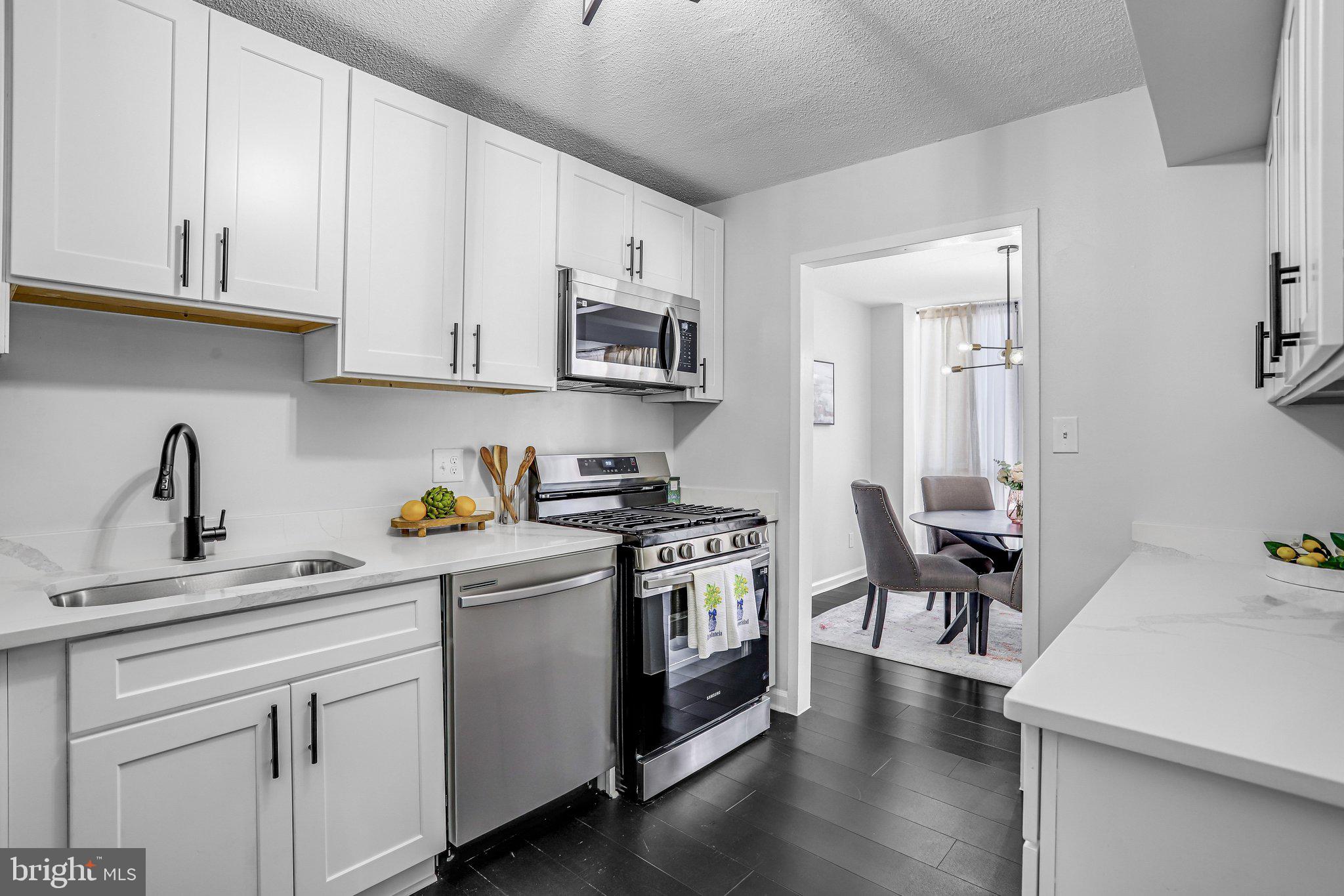 1836 Metzerott Road, Unit 627 Adelphi, MD 20783 - Photo 7 of 27 a kitchen with stainless steel appliances granite countertop a sink a stove and cabinets