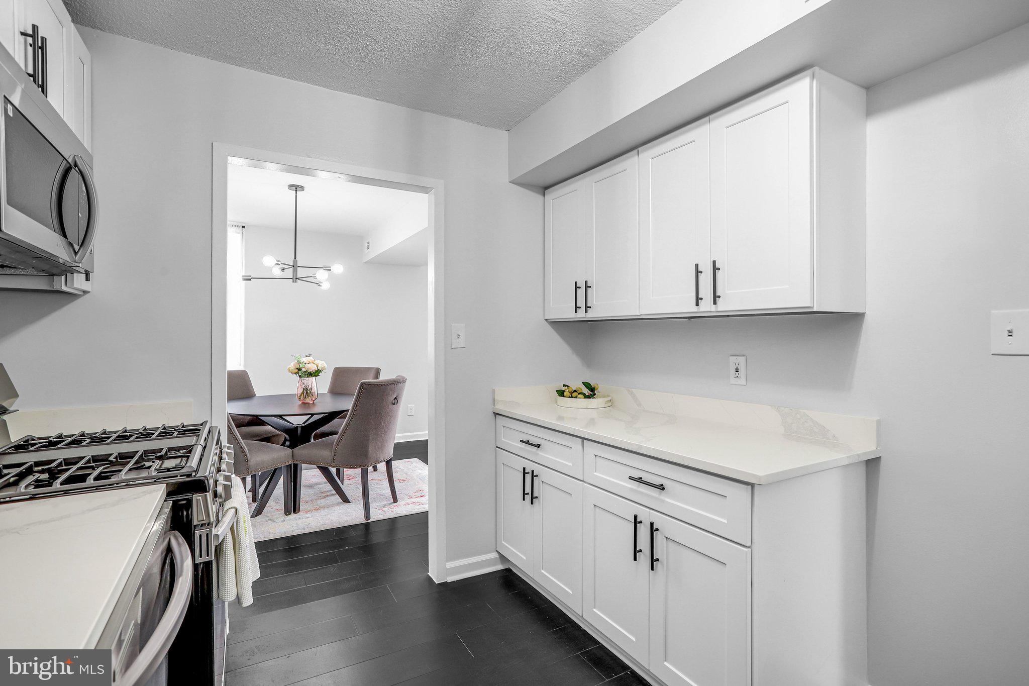 1836 Metzerott Road, Unit 627 Adelphi, MD 20783 - Photo 8 of 27 a kitchen with white cabinets and sink