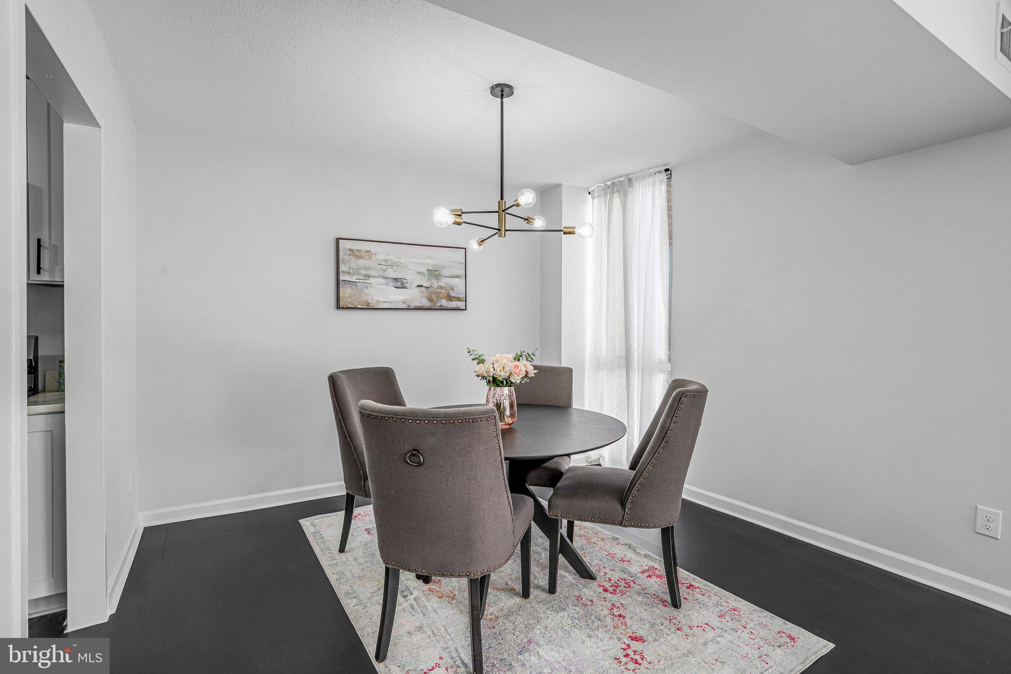 1836 Metzerott Road, Unit 627 Adelphi, MD 20783 - Photo 10 of 27 a view of a dining room with furniture window and wooden floor