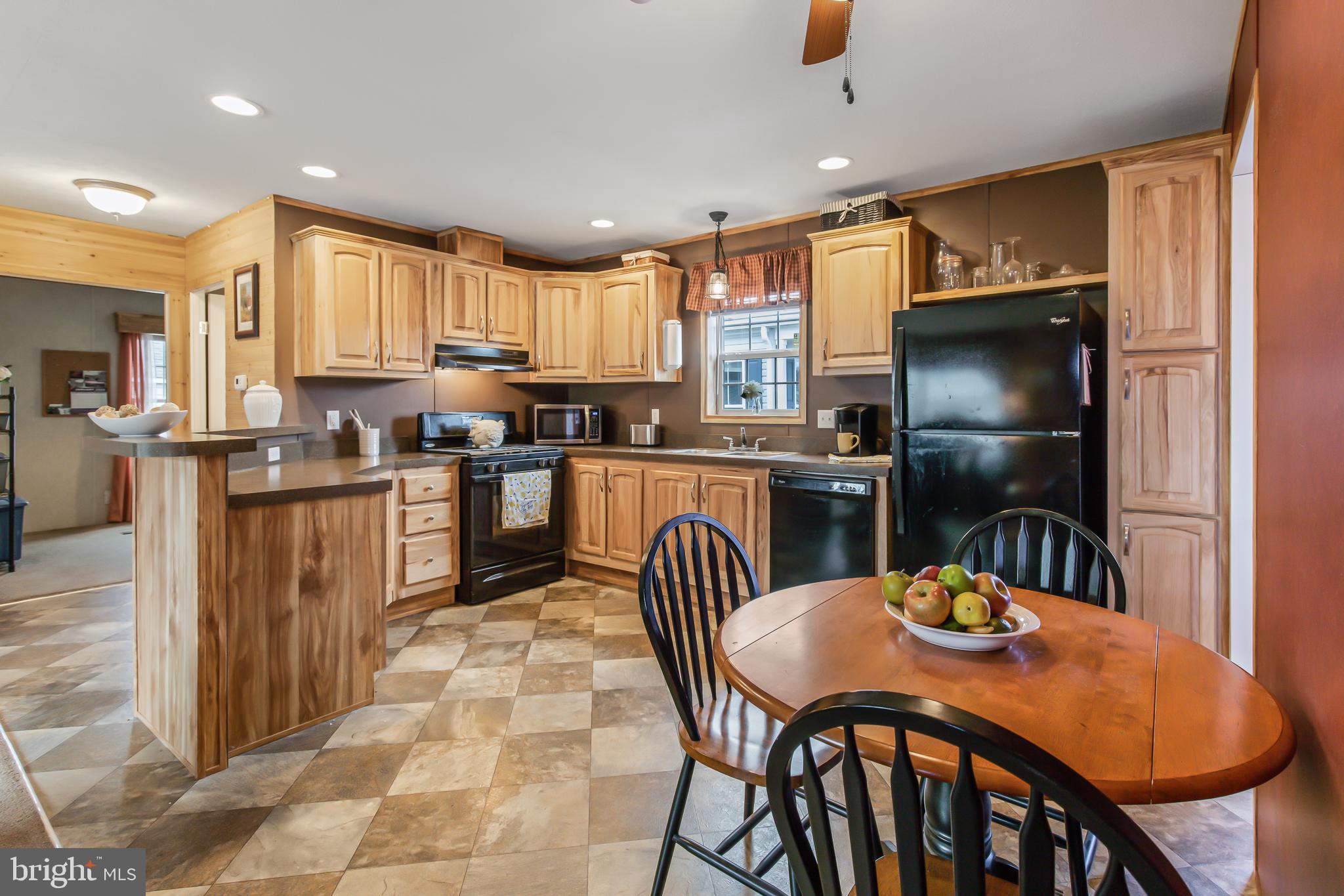 a kitchen with stainless steel appliances granite countertop a kitchen island a stove a dining table and chairs