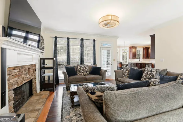 a living room with furniture a fireplace and a large window