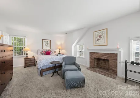 a bedroom with furniture and a fireplace