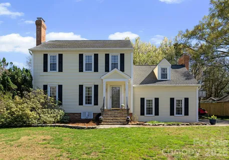 a front view of a house with a yard and porch
