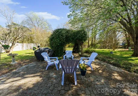 a view of a chairs and table in backyard