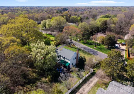 an aerial view of house with a yard