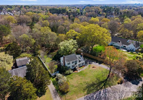 an aerial view of a house with yard swimming pool and lake view