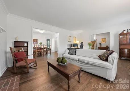 a living room with furniture a rug and a table