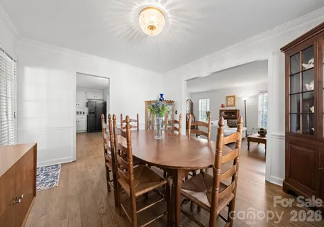 a dining room with furniture and wooden floor