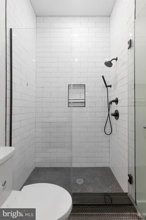 a bathroom with a toilet and a shower