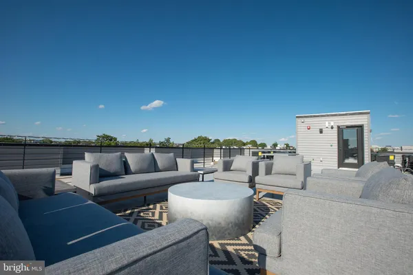 a view of a terrace with couches and city view