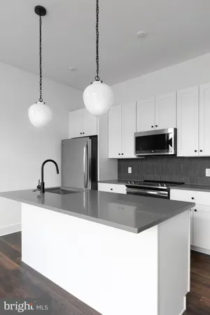 a kitchen with stainless steel appliances granite countertop a sink a stove and a counter top space