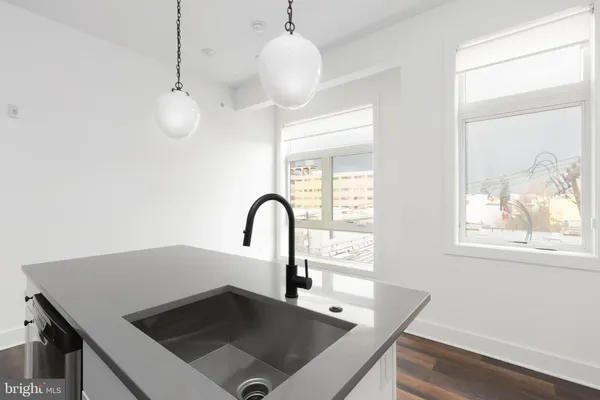a kitchen with a table chairs and a window