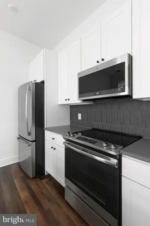 a kitchen with appliances and cabinets