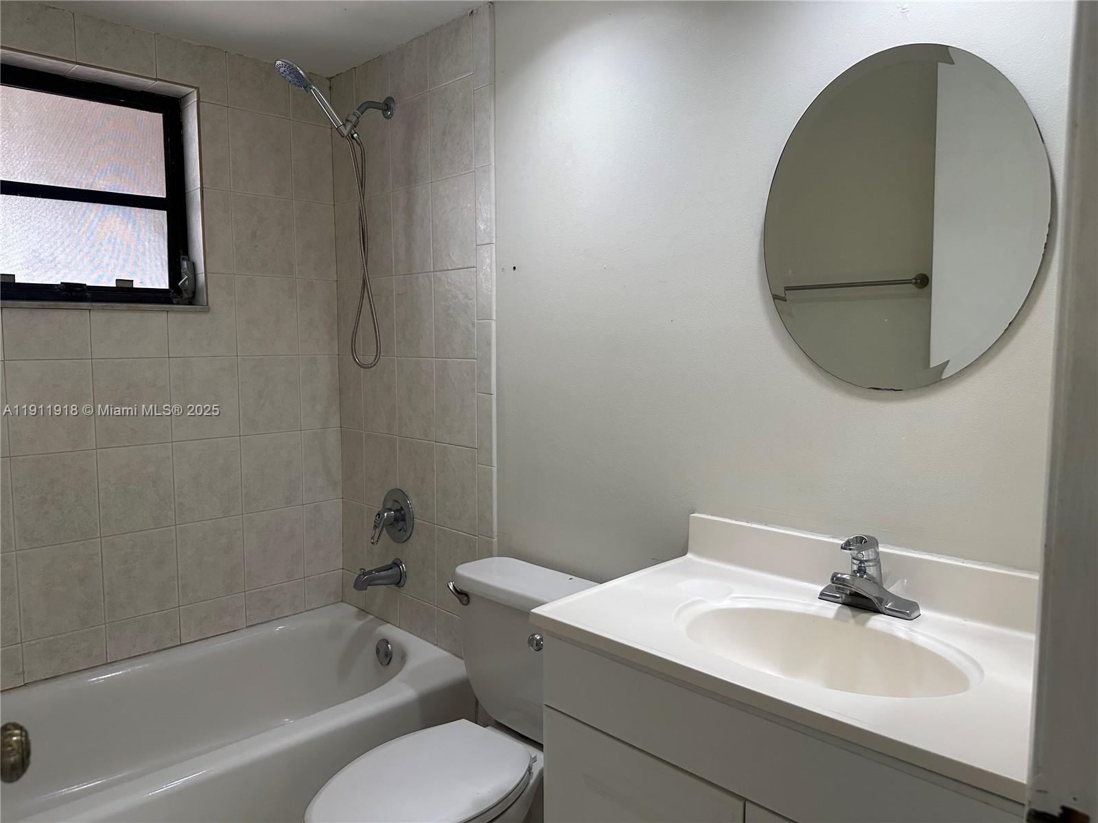 11354 Southwest 87th Terrace, Unit 11354 Miami, FL 33173 - Photo 13 of 25 a bathroom with a sink and mirror