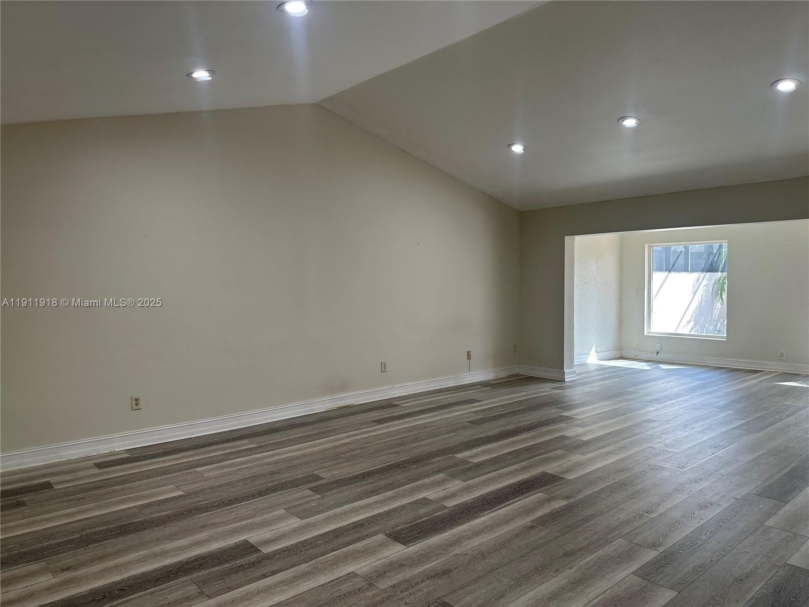 11354 Southwest 87th Terrace, Unit 11354 Miami, FL 33173 - Photo 15 of 25 an empty room with wooden floor and windows