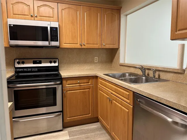 a kitchen with a sink stove and microwave