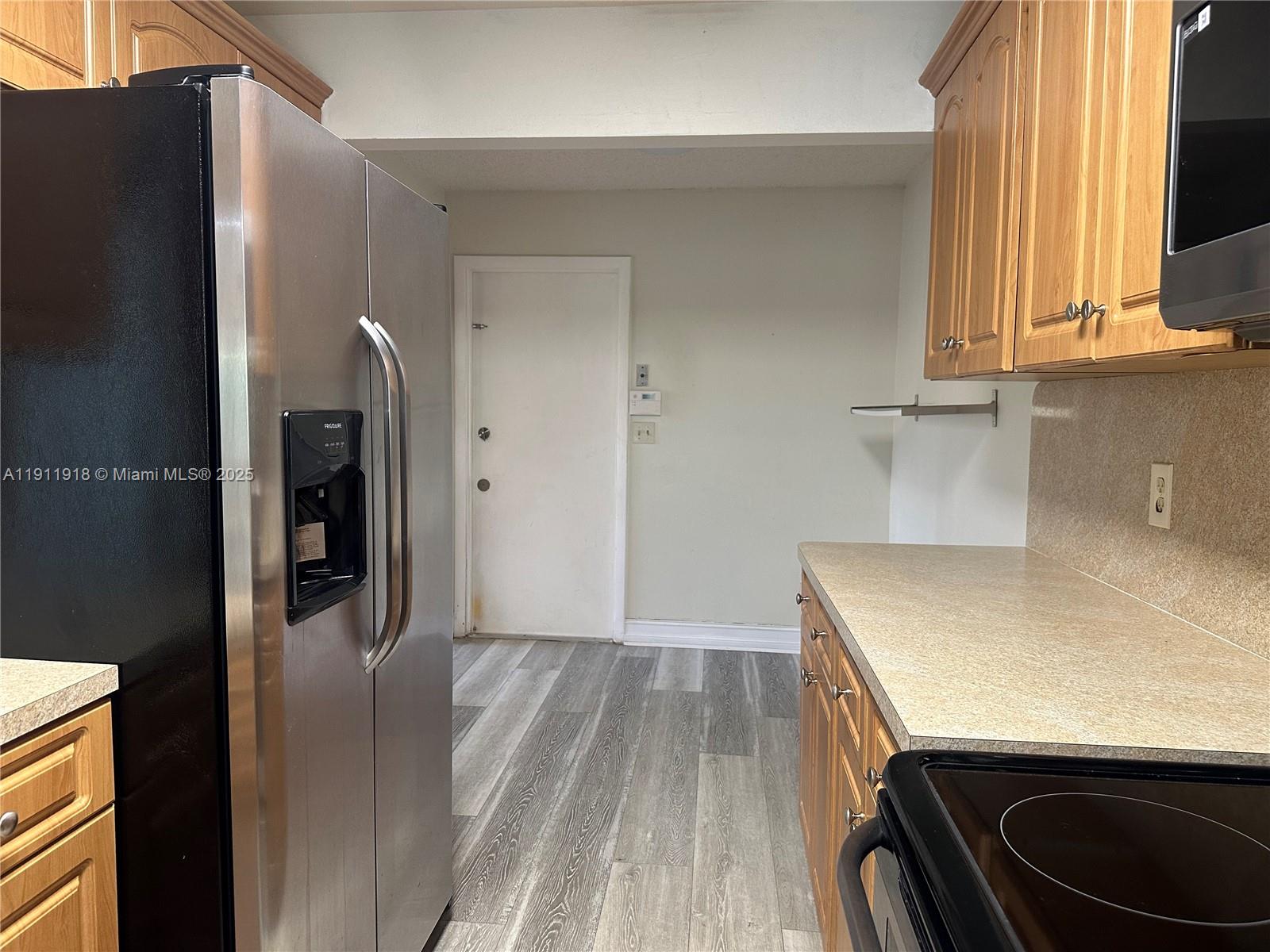 11354 Southwest 87th Terrace, Unit 11354 Miami, FL 33173 - Photo 20 of 25 a view of a kitchen cabinets and a wooden floor
