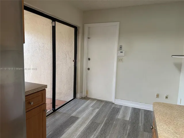 a view of wooden floor and cabinets in a room