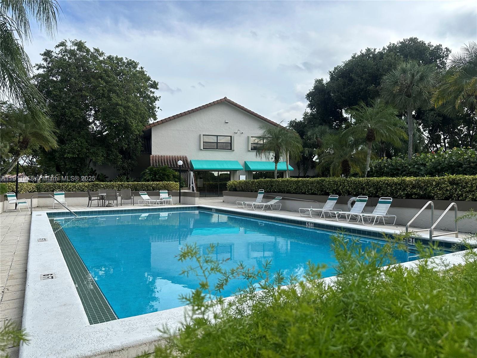 11354 Southwest 87th Terrace, Unit 11354 Miami, FL 33173 - Photo 24 of 25 a view of a house with pool yard and a chairs