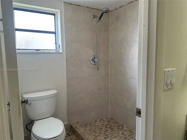 a white toilet sitting next to a bathroom sink
