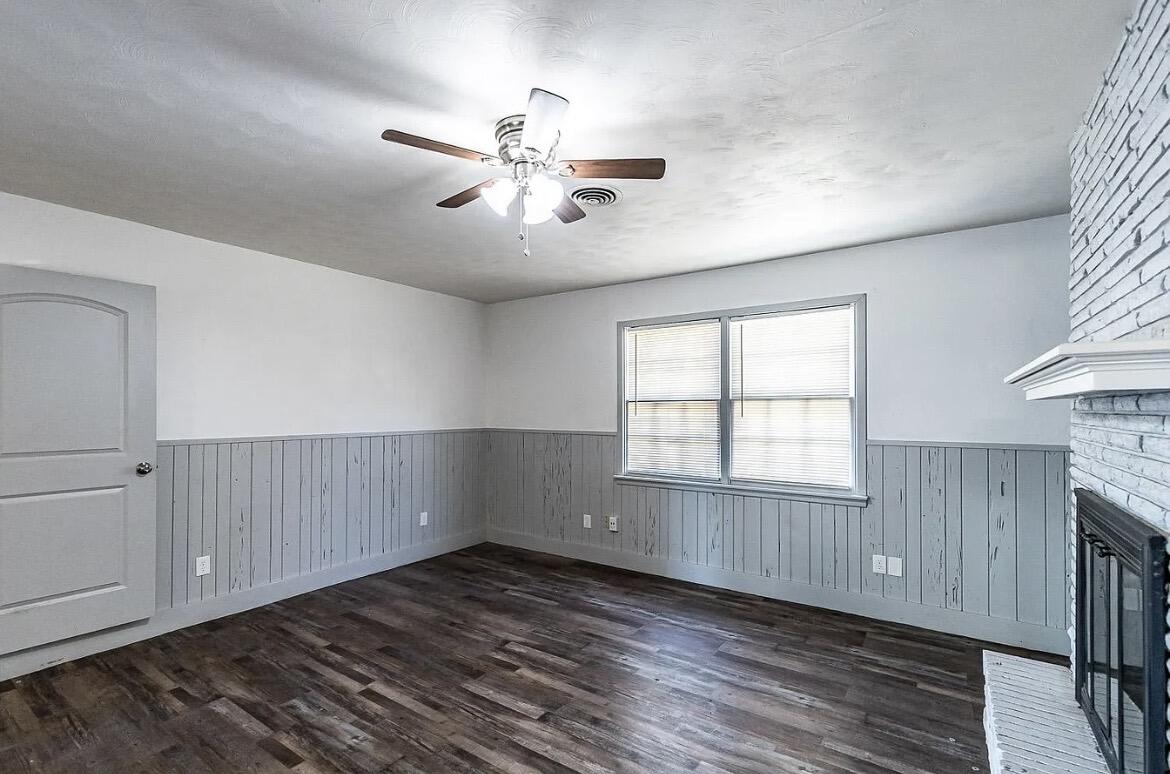 5426 43rd Street Lubbock, TX 79414 - Photo 13 of 27 a view of an empty room with a window and wooden floor