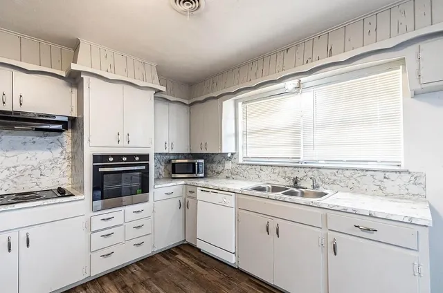 a kitchen with appliances cabinets and a sink