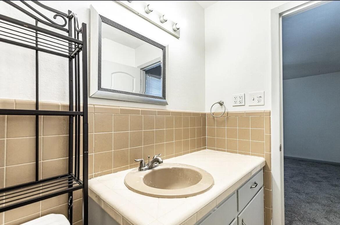 5426 43rd Street Lubbock, TX 79414 - Photo 20 of 27 a bathroom with a sink and a mirror