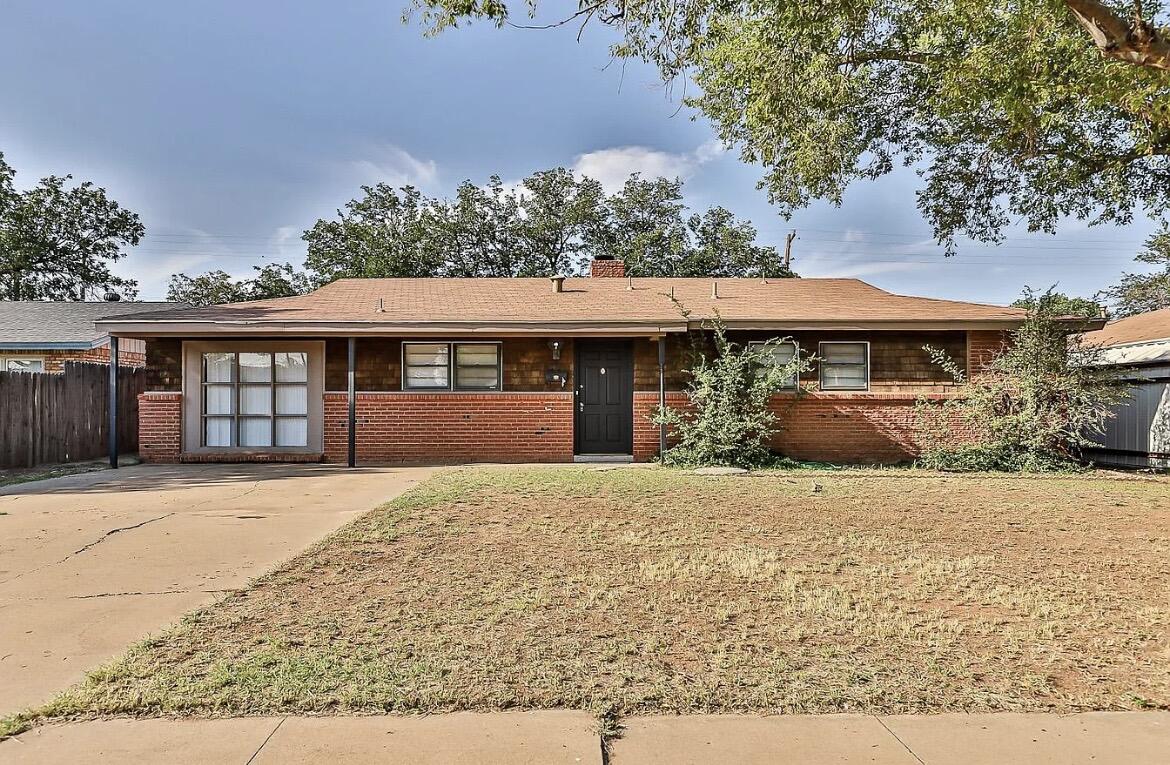 5426 43rd Street Lubbock, TX 79414 - Photo 2 of 27 a front view of a house with a yard