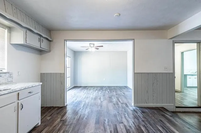 an entryway with wooden floor and cabinet