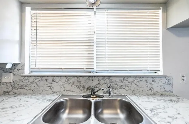 a bathroom with a sink and a window