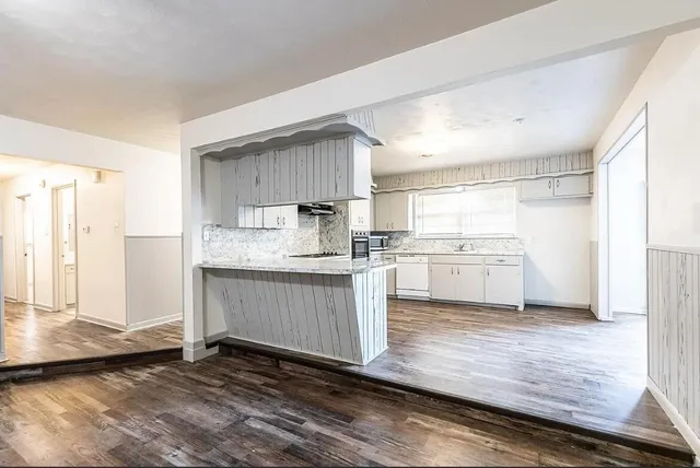 a kitchen with a refrigerator sink and cabinets