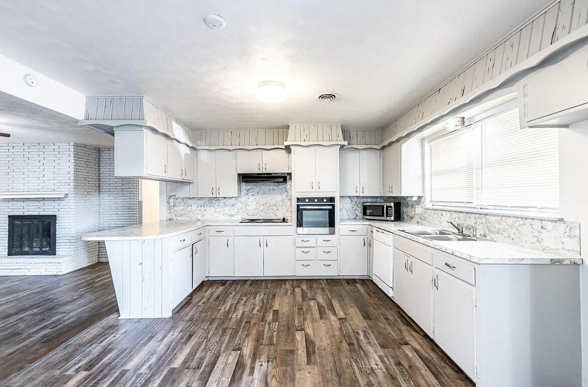 5426 43rd Street Lubbock, TX 79414 - Photo 8 of 27 a kitchen with a sink window and cabinets