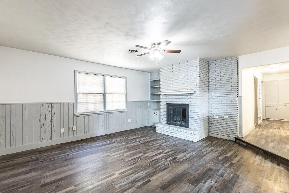 5426 43rd Street Lubbock, TX 79414 - Photo 9 of 27 an empty room with windows and fireplace