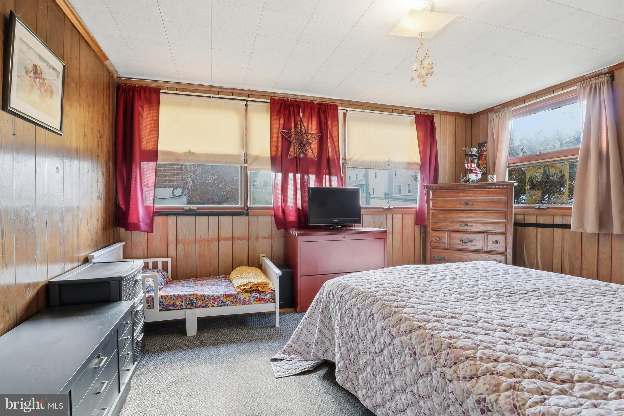 225 North Main Street Manchester, PA 17345 - Photo 19 of 53 a bedroom with a bed and large windows