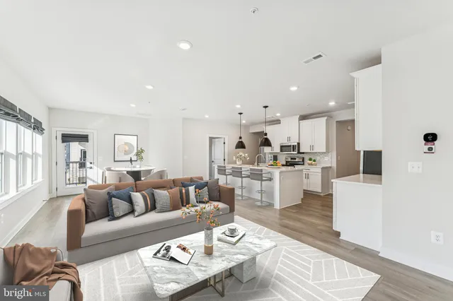 a living room with furniture and kitchen view