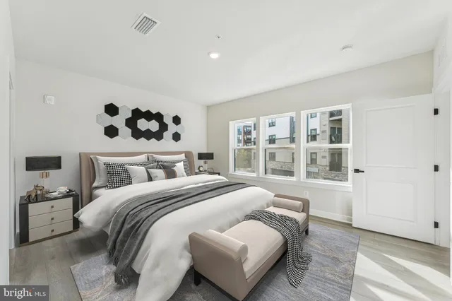 a bedroom with a large bed and a window